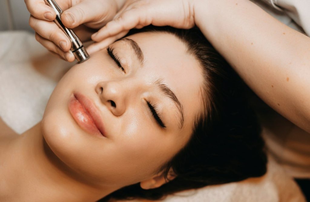 A woman getting a microdermabrasion facial. 